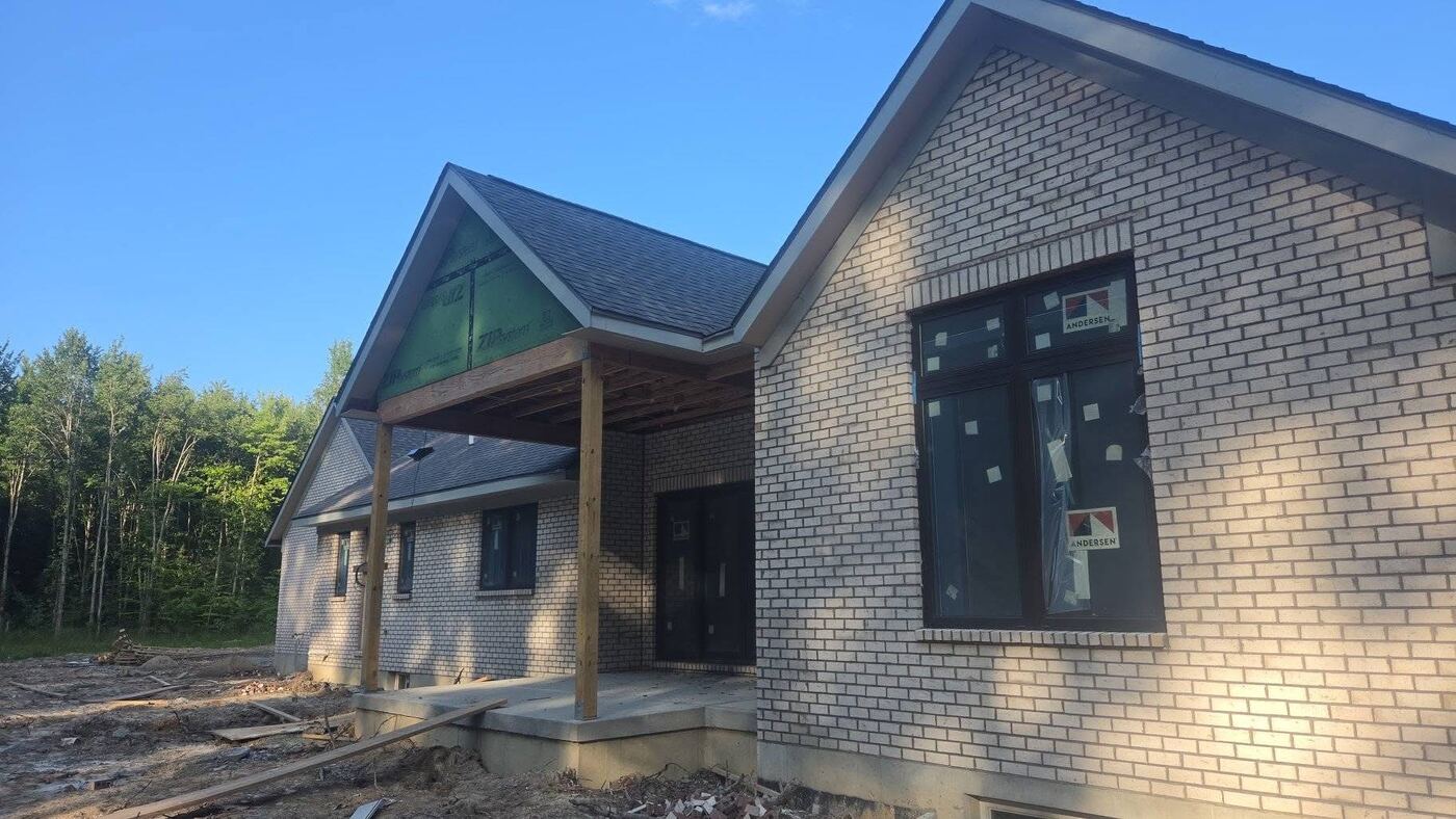 Two-story custom home combining brick and stone masonry